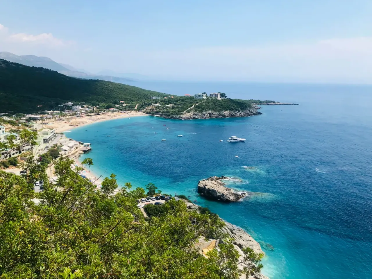 Aerial view of Jale Beach bay with boats and turquoise water