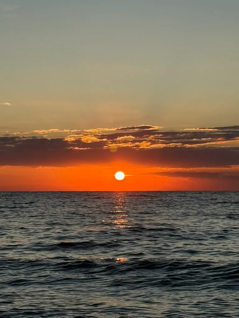 Sunset over Spile bay in Himara — driving the Albanian Riviera with the right navigation app matters