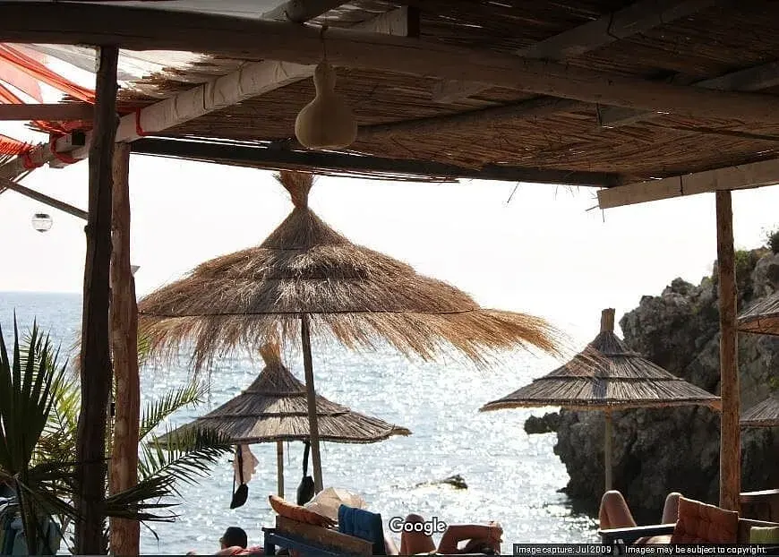 Rescue @ The Beach bar's covered seating with high tables on Himara beach overlooking the bay