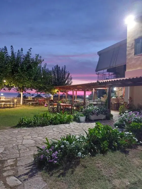 Covered terrace and garden of the farmhouse at Agrotourism Himara