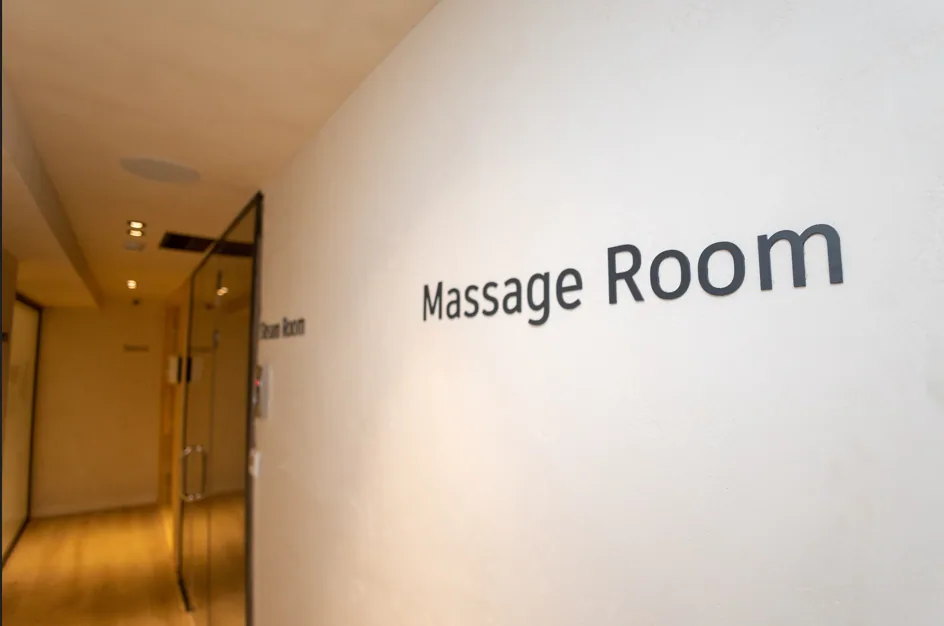 The Massage Room sign on the spa corridor wall