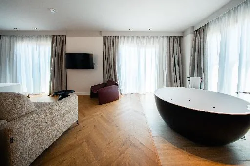 The same black bath seen from the other side of the room
