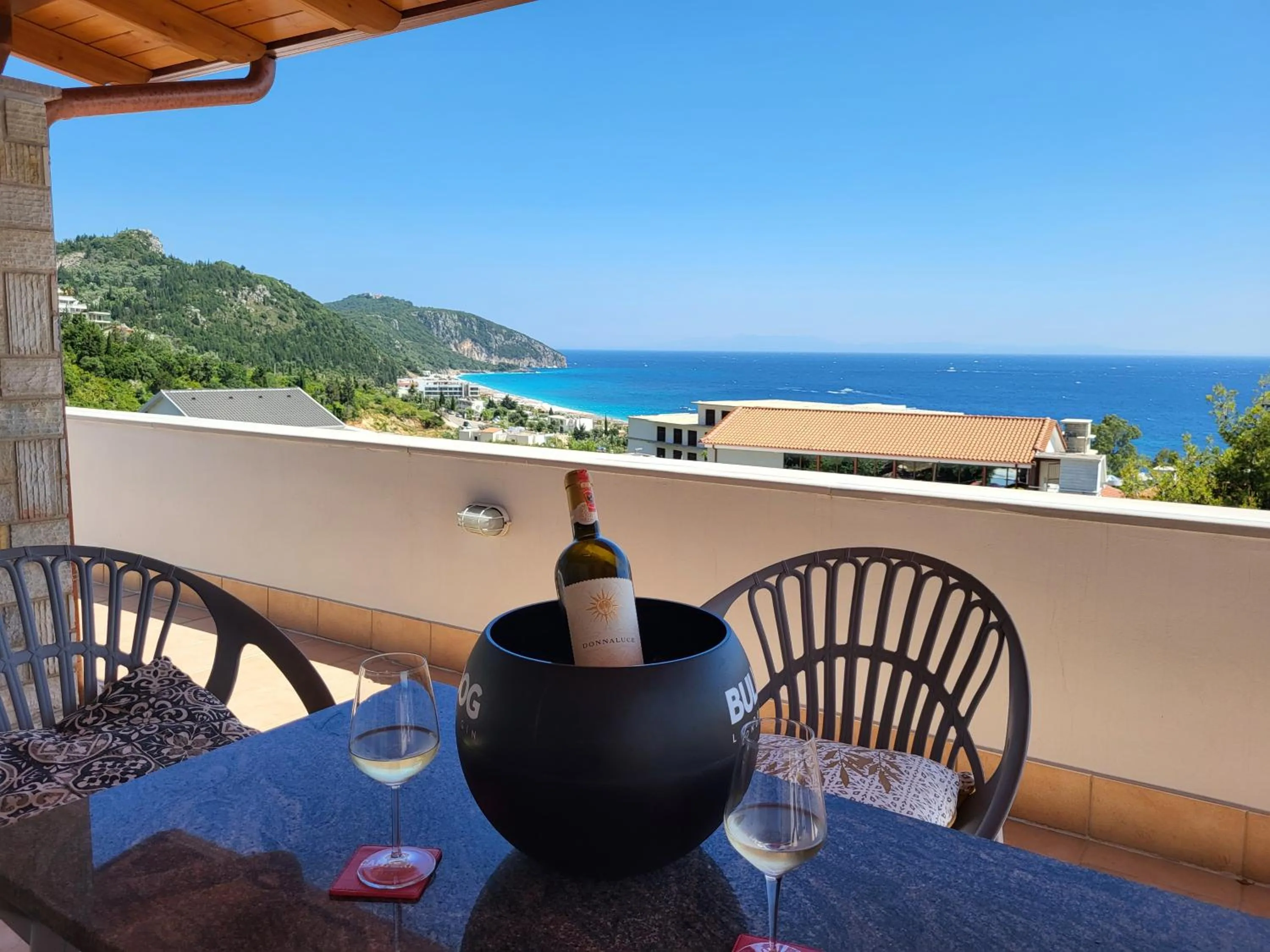 A terrace table at Augustus Hotel looking down over Dhërmi Bay to the sea