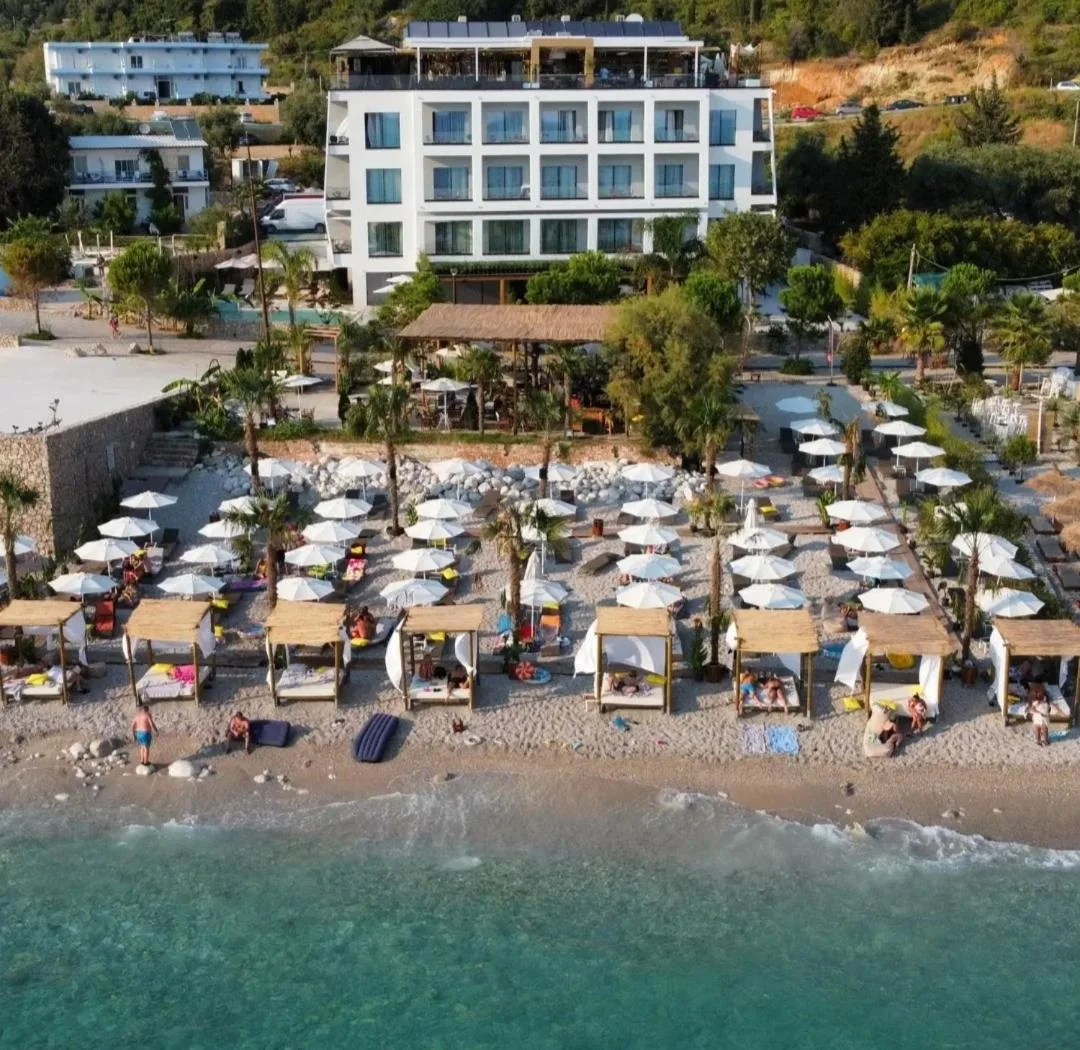 Hotel Stephen Seaside from the air, behind its pool and its beach area on Dhërmi Beach